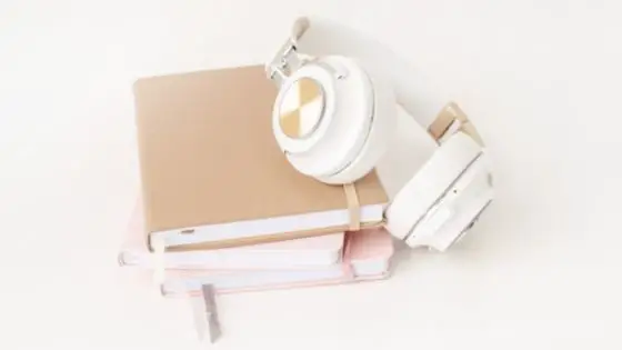 White headphones on top of a set of books