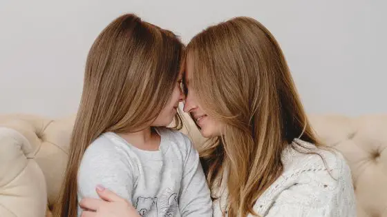 Mom and daughter embracing and holding each other lovingly