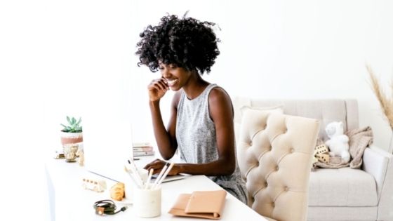 African-American woman at her desk working and smiling