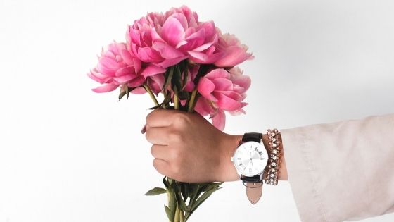 Woman holding pink flowers