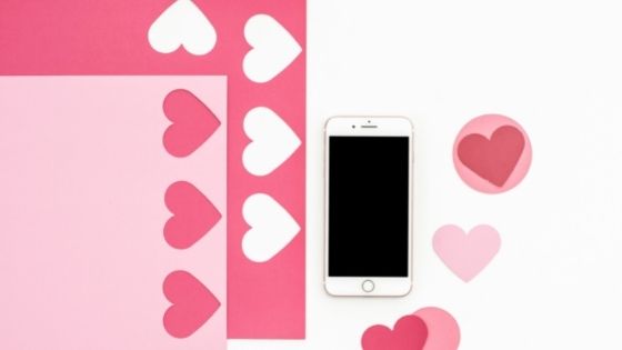 Hearts and Love notes next to mobile phone