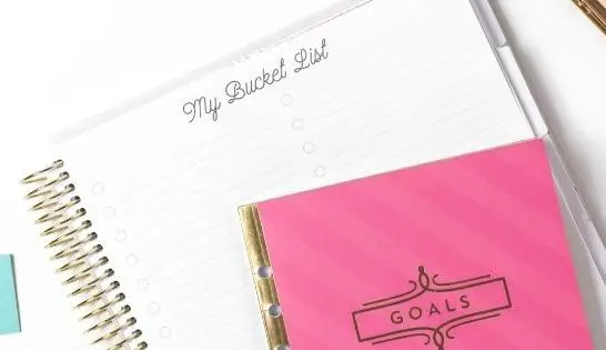 Pink Goals Notebook on top of blank bucket list page