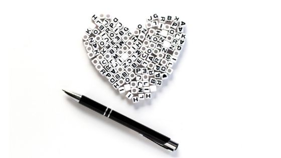 Black pen next to a heart shape