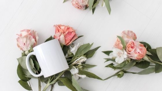Mug lying on top of roses