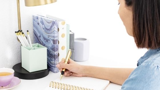 Woman writing in notebook SOAP Bible study