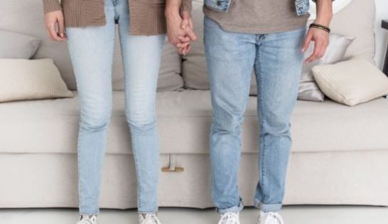 Couple standing holding hands
