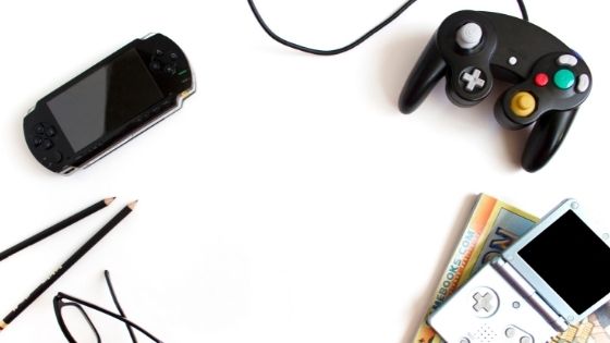 Desk with game controller, glasses, books and pencils