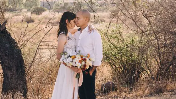 Caucasian couple on their wedding day embracing intimately