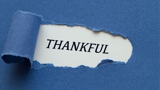 Paper with the word Thankful written on it