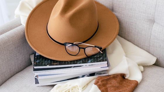 Woman's scarf, hat and books on a couch
